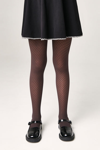 Brown patterned tights worn with a black skirt and black mary jane shoes against a plain white background.