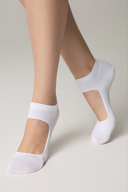 A pair of white, low-cut ballet-style socks worn on feet, featuring an open-top design that exposes the bridge of the foot.