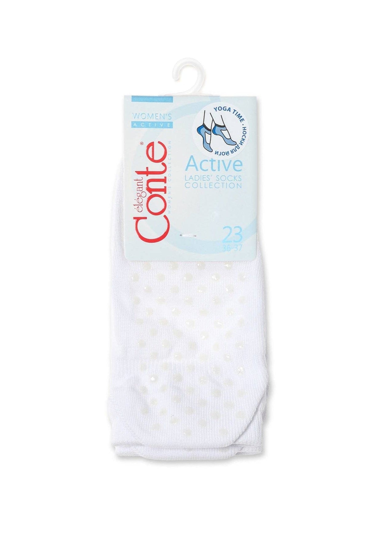 A pair of white yoga socks with small circular grips on the sole are displayed in their original retail packaging.