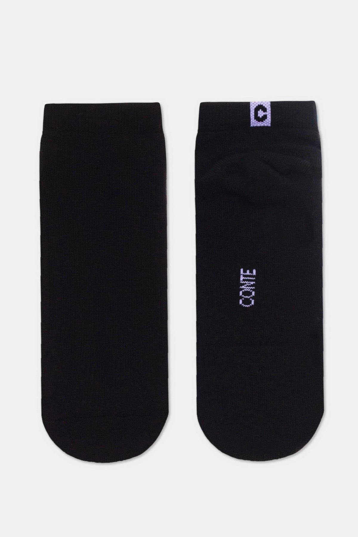 A pair of black ankle socks, one viewed from the front and the other viewed from the back, featuring a small purple square logo with a white emblem on the top cuff and purple text branding on the heel.