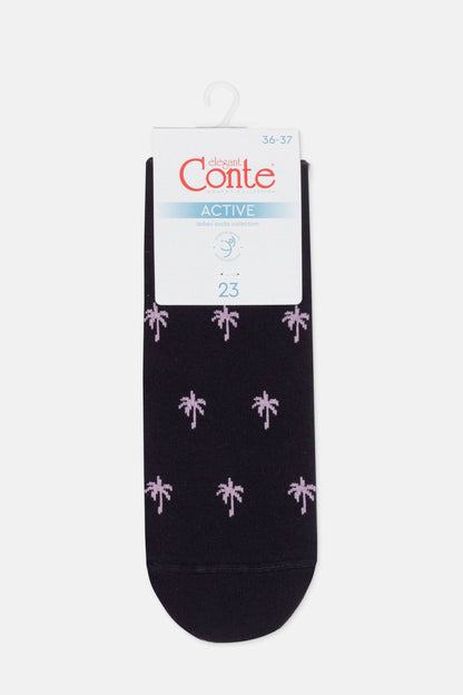 A pair of dark-coloured ankle socks featuring a repeating pattern of light pink palm trees on a cardboard retail hanger.