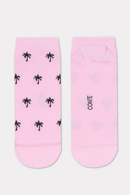 A pair of light pink socks featuring a repeating pattern of small black palm trees on the front and the word CONTE printed on the back.