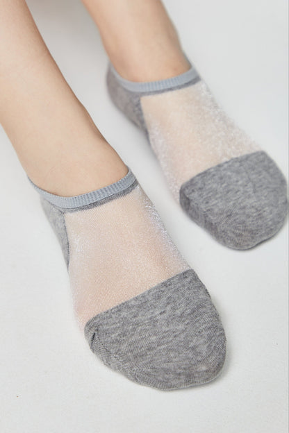 A pair of grey low-cut socks featuring a sheer, shimmering mesh panel across the top of the foot.