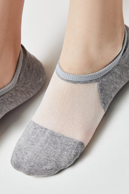 A pair of low-cut, ankle socks feature a color-blocked design with gray knit fabric at the heel and toe, transitioning into a sheer, pale pink mesh panel across the top of the foot.