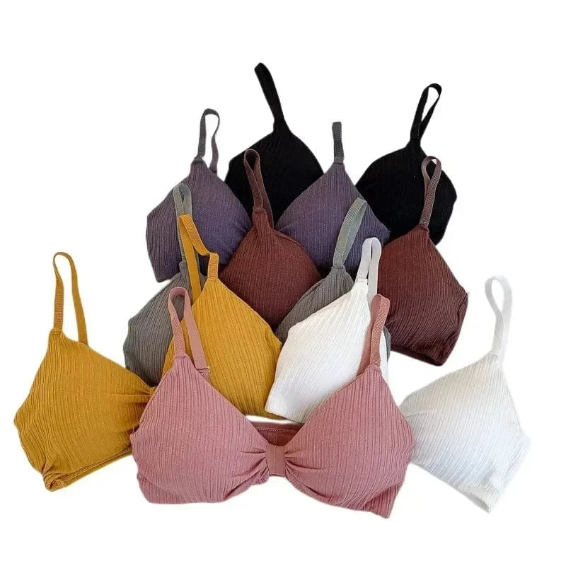 A collection of ribbed knit bralettes in various colors including yellow, pink, white, brown, grey, and black arranged against a white background.