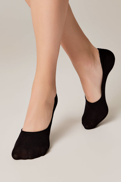 Black no-show liner socks worn on feet against a neutral background.