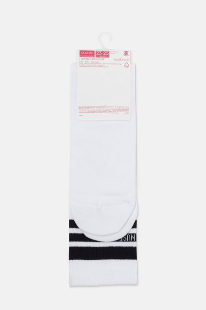 A pair of white knee-high socks with two horizontal black stripes at the cuffs, presented on a branded cardboard hanger.