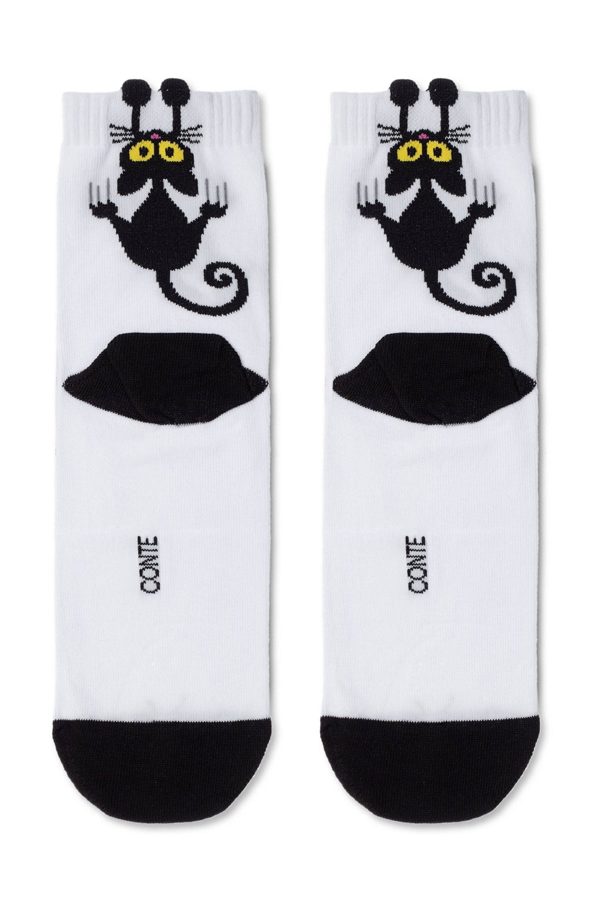 A pair of white crew socks featuring a cartoon black cat character with yellow eyes and raised paws, along with a black UFO graphic and black toe sections.