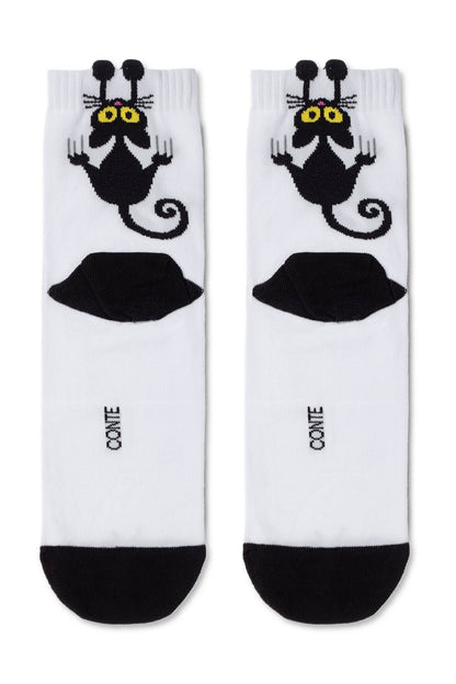 A pair of white crew socks featuring a cartoon black cat character with yellow eyes and raised paws, along with a black UFO graphic and black toe sections.
