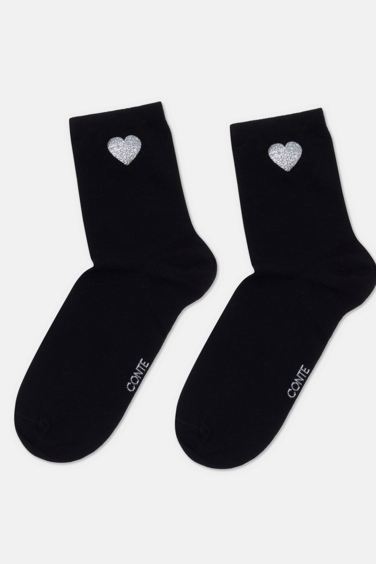 A pair of black ankle socks featuring a small, glittery silver heart detail on the outer side and the text "CONTE" printed in white on the foot.