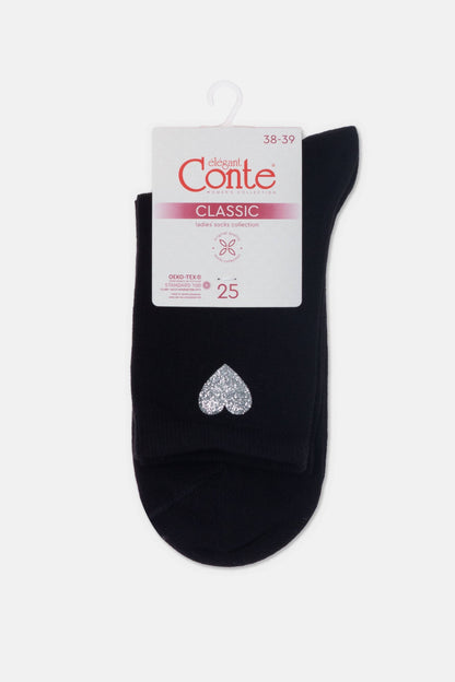 A pair of black women's socks hanging from a white card with a silver glitter heart accent on the ankle.