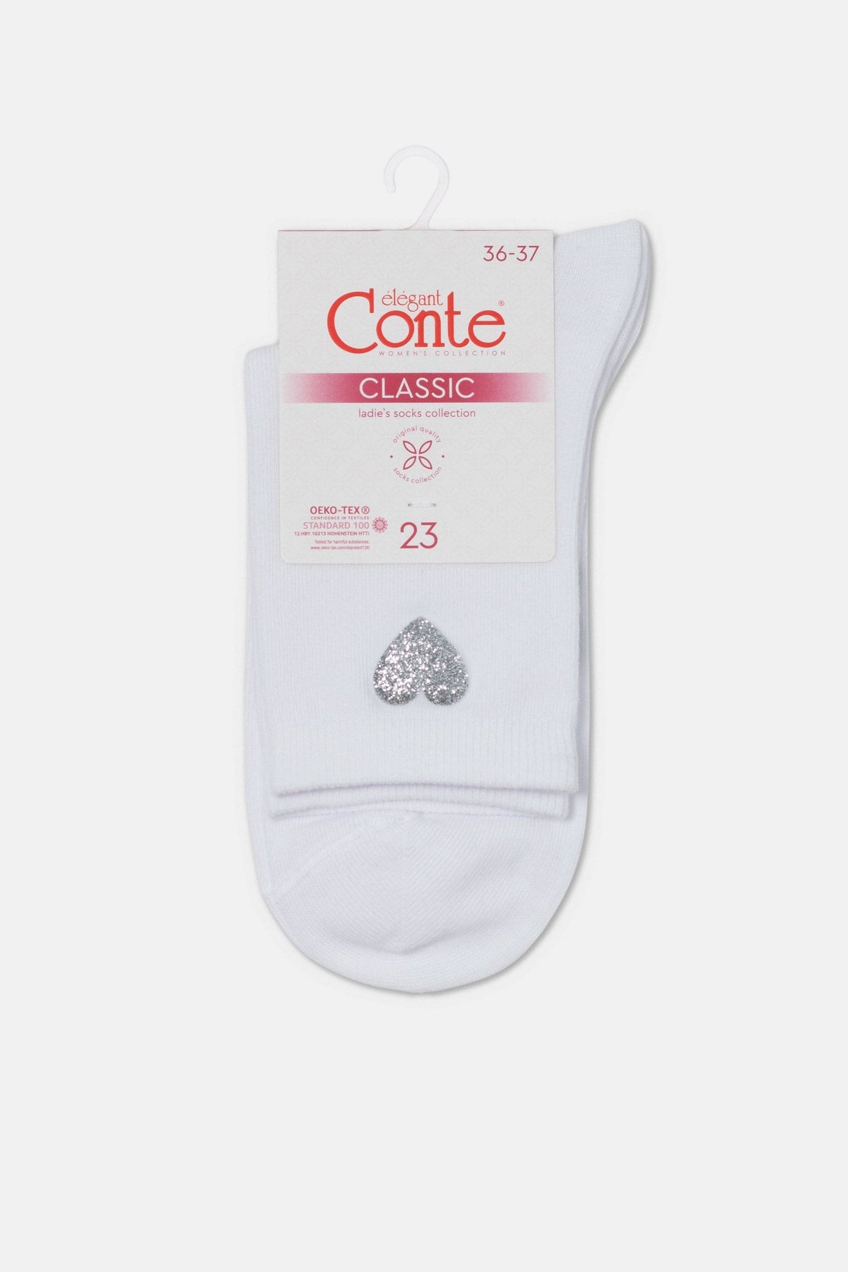 A pair of white ankle socks featuring a sparkly silver glitter heart detail, displayed on a cardboard hanger.