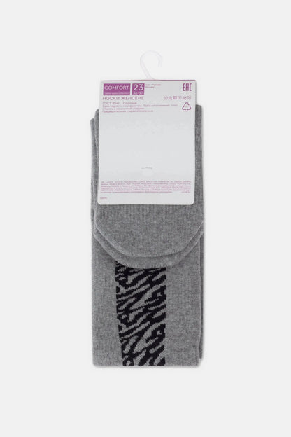 A pair of grey mid-calf socks with a black abstract pattern near the cuff, displayed on a cardboard hanger.