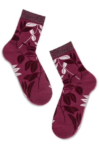 A pair of plum-colored ankle socks featuring a darker floral leaf pattern and a shimmery metallic cuff.