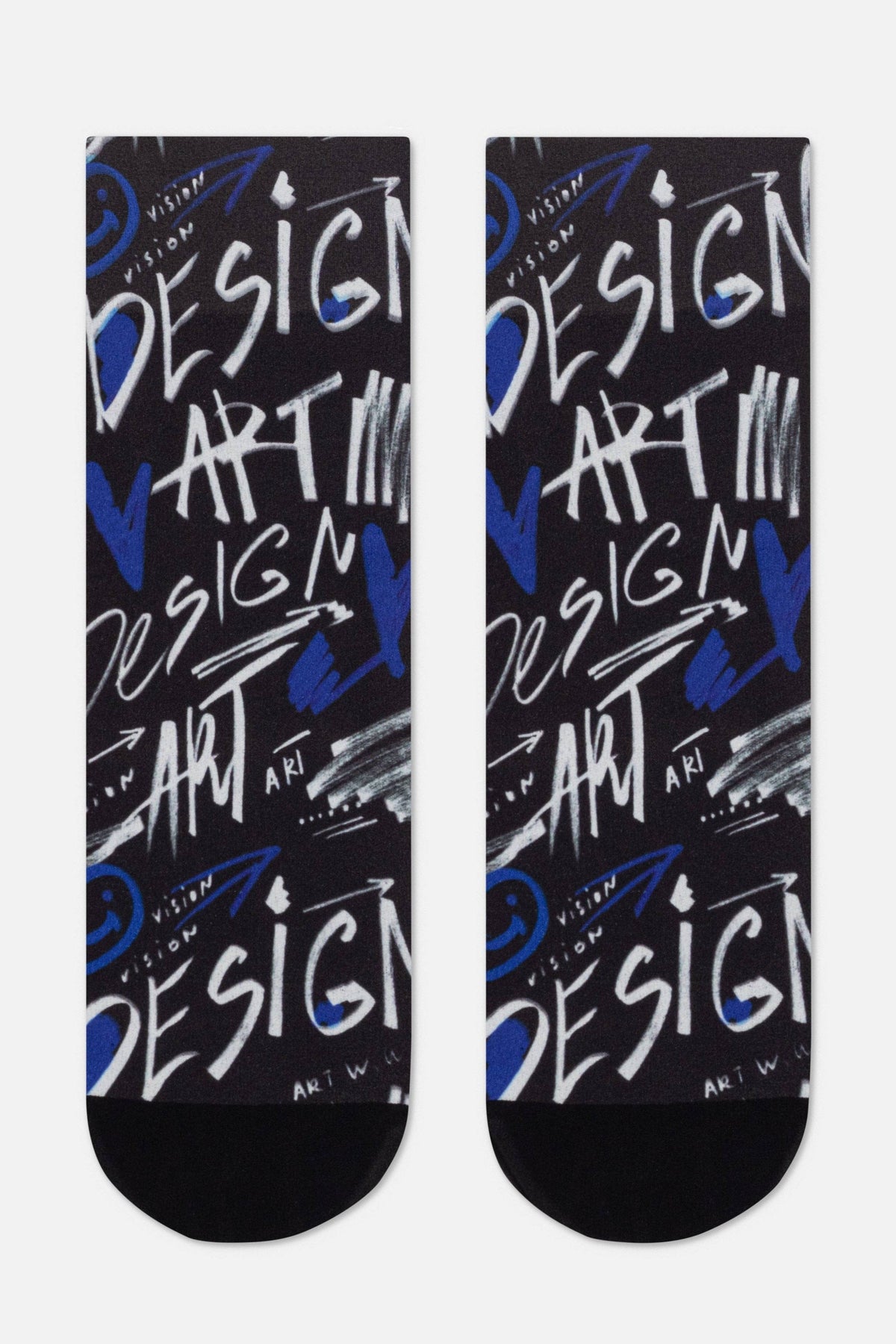 A pair of black crew socks featuring a repeating graffiti-style print with the words DESIGN and ART in white and blue, accented by abstract strokes and small smiley face symbols.