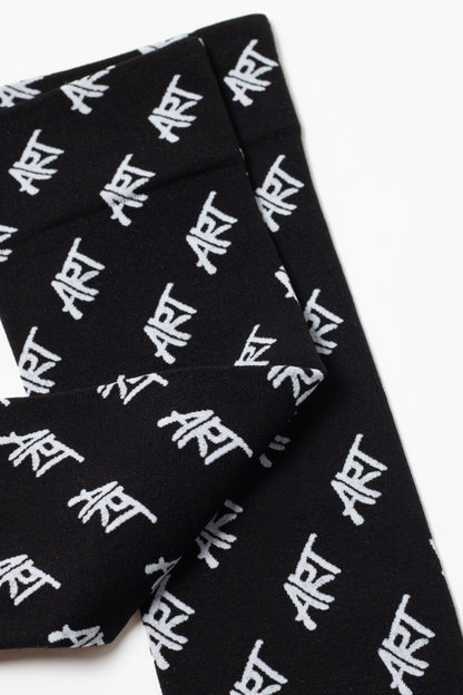 Black socks feature a repeating white graffiti-style text pattern spelling the word ART across the fabric.