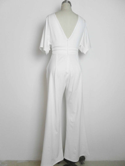 A white short-sleeved jumpsuit on a mannequin, featuring a deep V-neckline on the back and wide-leg trousers.