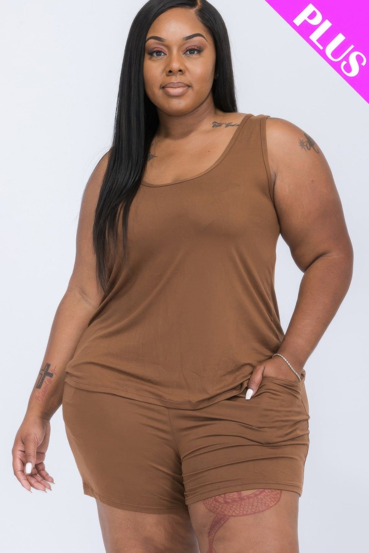 A plus-size model wears a matching brown tank top and shorts set with a scoop neckline and visible side pockets.