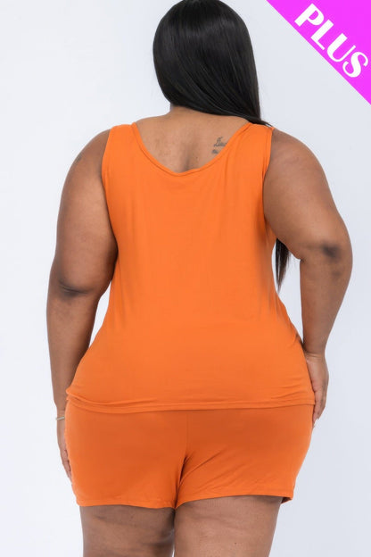 A back view of a woman wearing a bright orange sleeveless tank top and matching shorts.