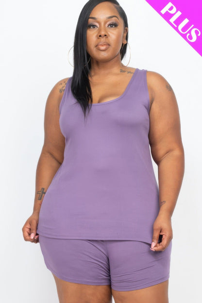 A plus-size model wearing a purple scoop-neck tank top with matching shorts against a plain white background.