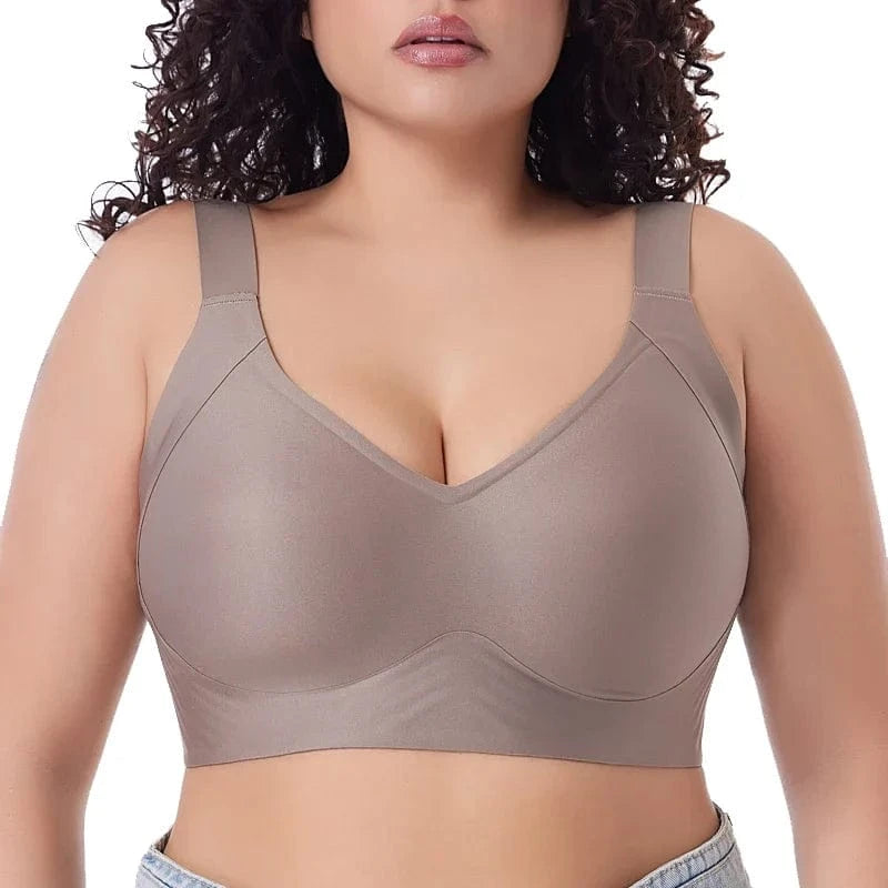 A beige wireless bra featuring wide shoulder straps and a smooth, full-coverage design on a person.