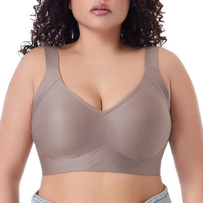 A beige wireless bra featuring wide shoulder straps and a smooth, full-coverage design on a person.