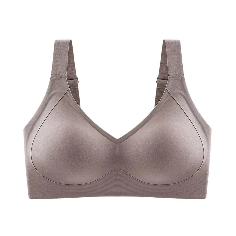 A taupe-colored wireless bra featuring molded cups, wide supportive straps, and a seamless design against a white background.
