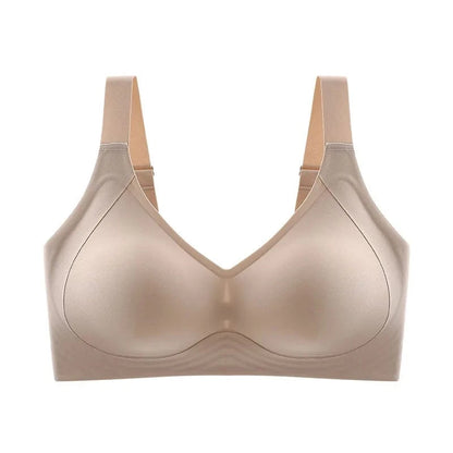 A beige wireless bra featuring wide straps and smooth, molded cups in a clean studio setting.