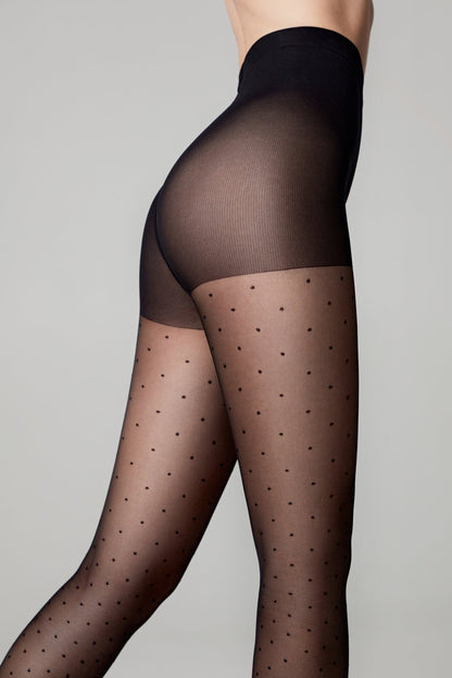 Sheer black tights with a small polka dot pattern and a solid high-waisted band worn against a plain grey background.