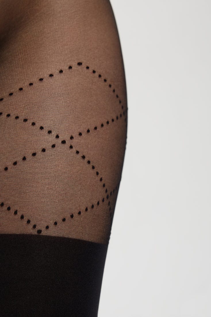 Sheer black pantyhose featuring a textured diamond pattern formed by small dot accents, ending in a solid black opaque section at the lower thigh.