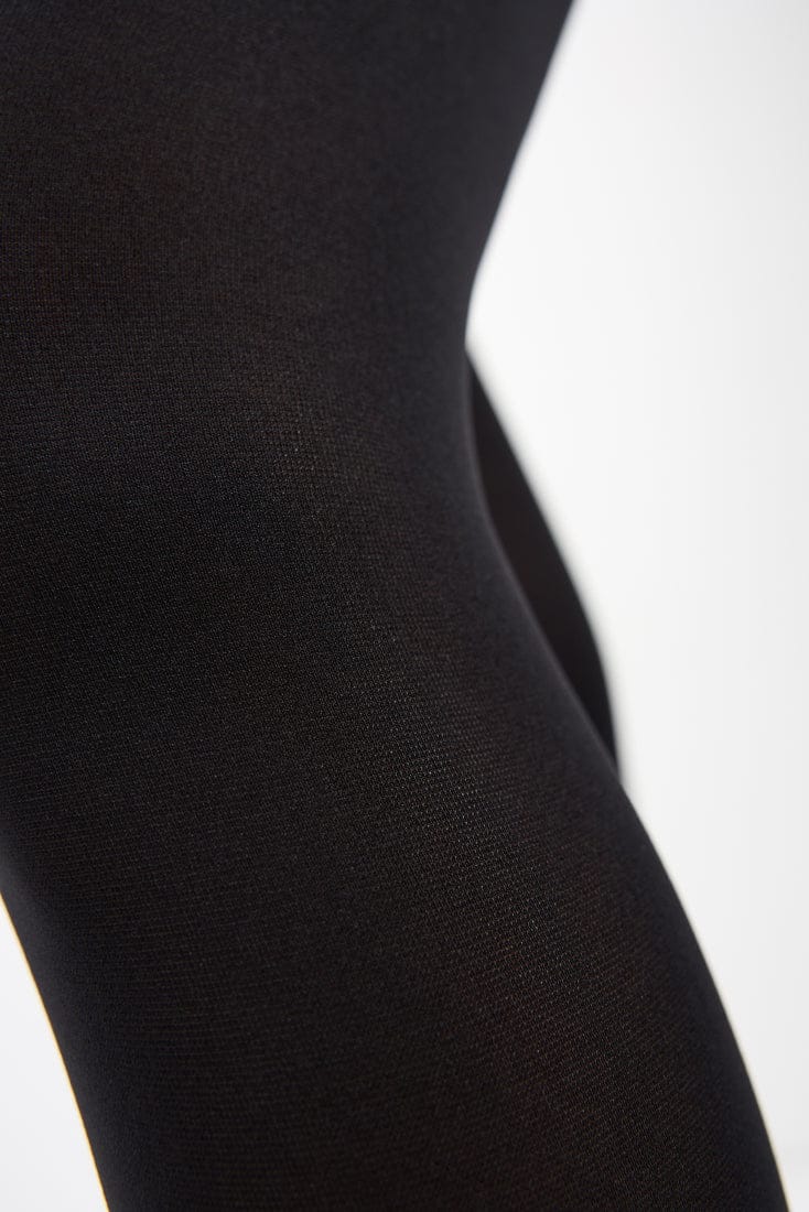 A close-up view of black opaque fabric showing the fine, textured knit detail.