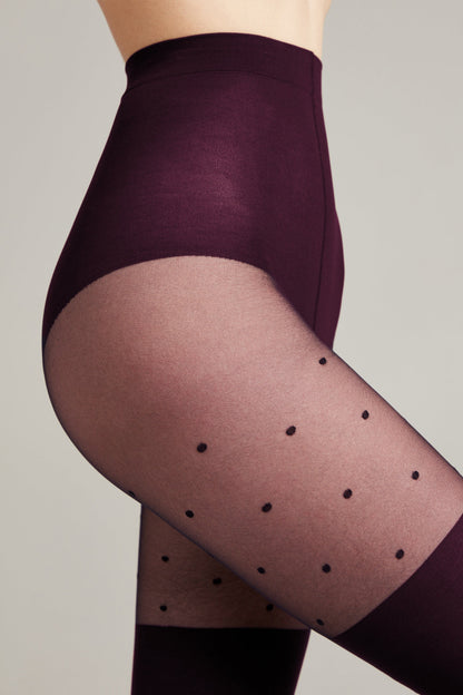 A pair of dark purple opaque tights featuring a sheer section on the thigh decorated with small black polka dots.