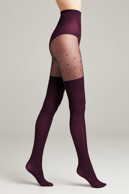 Burgundy tights featuring a high-waisted solid design with a sheer polka dot panel across the upper thighs and opaque fabric covering the rest of the legs.