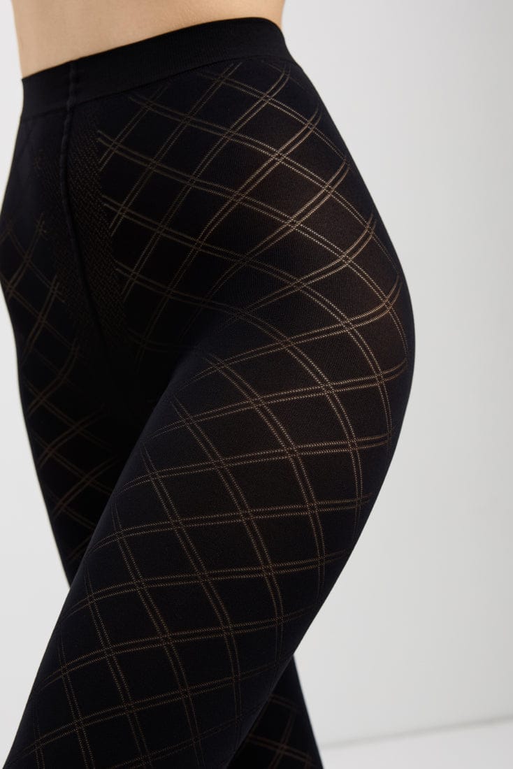 Black tights featuring a sheer diamond pattern design worn on a person's legs.