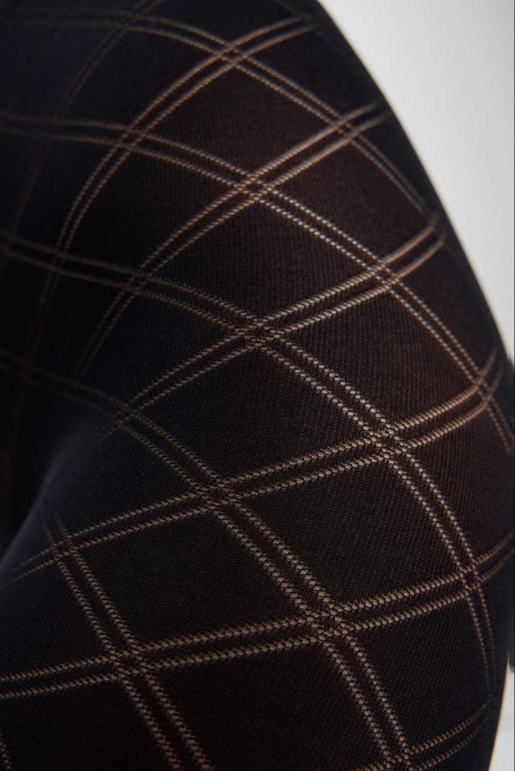 Black tights featuring a subtle, translucent diamond-shaped grid pattern across the fabric.