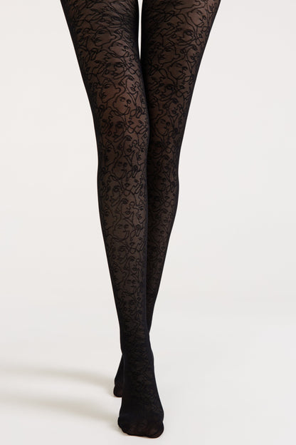 Black tights featuring a repeating continuous-line face pattern against a solid background worn on a pair of legs.