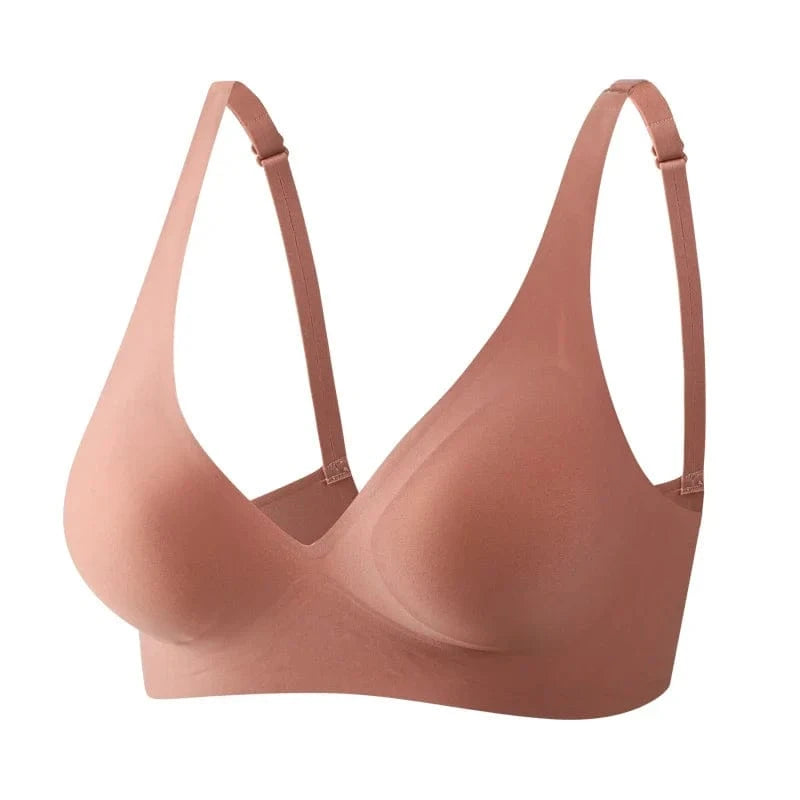 A seamless, dusty rose-colored wireless bra with adjustable straps and molded cups shown against a plain white background.