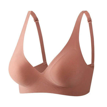 A seamless, dusty rose-colored wireless bra with adjustable straps and molded cups shown against a plain white background.