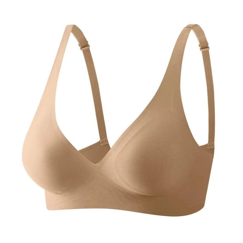 A beige wireless bra featuring a seamless, molded cup design with adjustable shoulder straps on a plain white background.