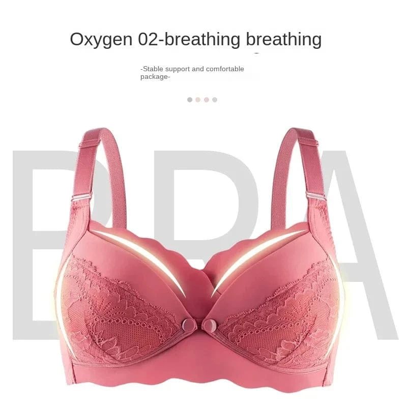 A pink, wireless, full-coverage bra with lace detailing on the cups and wide, adjustable shoulder straps against a white background.