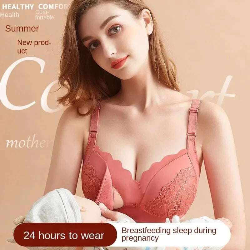 A coral-colored nursing bra featuring scalloped lace trim along the cups, worn by a woman holding a baby against a plain light-colored background.