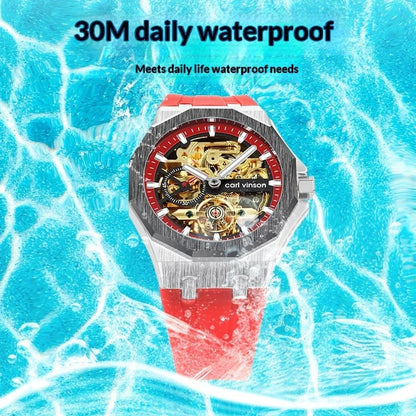 A skeletonized wristwatch with a silver octagonal bezel, black dial with red accents, and a bright red rubber strap, displayed against a background of rippling blue water.