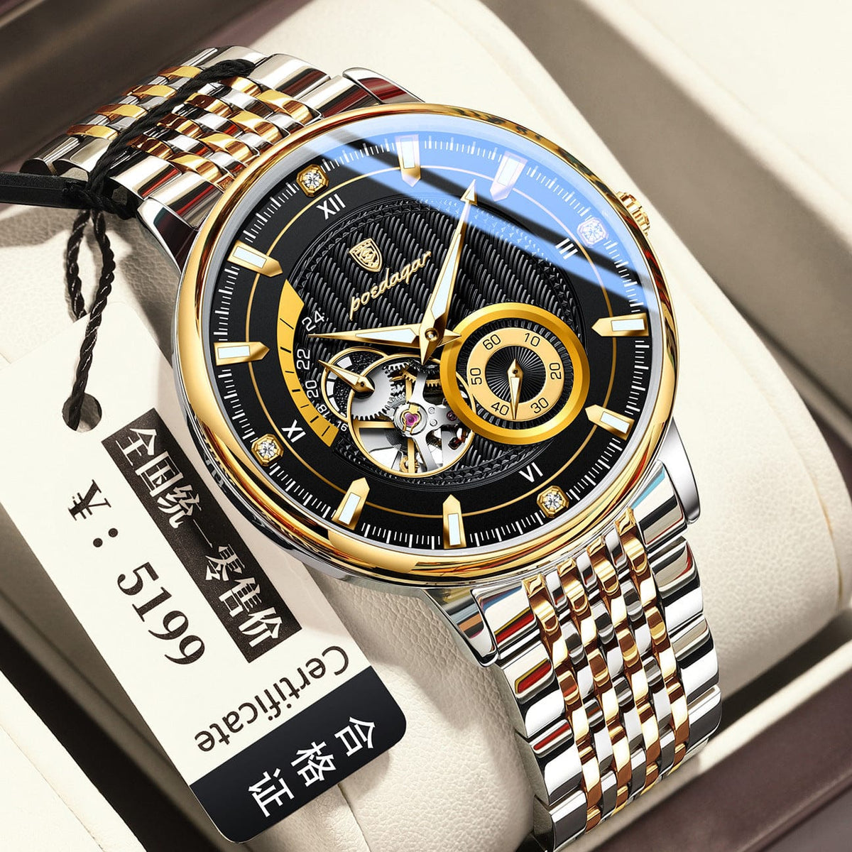 A round mechanical wristwatch featuring a black textured dial, gold-tone hour markers with crystals, and a two-tone gold and silver stainless steel link bracelet resting in a beige presentation box.
