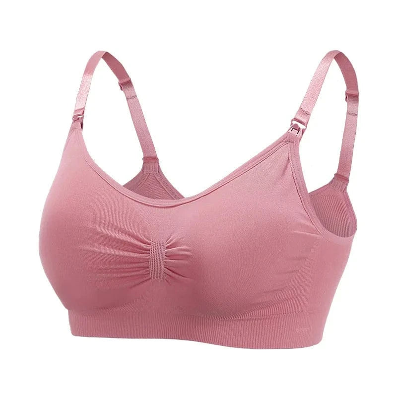 A dusty pink seamless nursing bra with adjustable straps, ruched detailing at the center front, and clasps at the top of the cups.