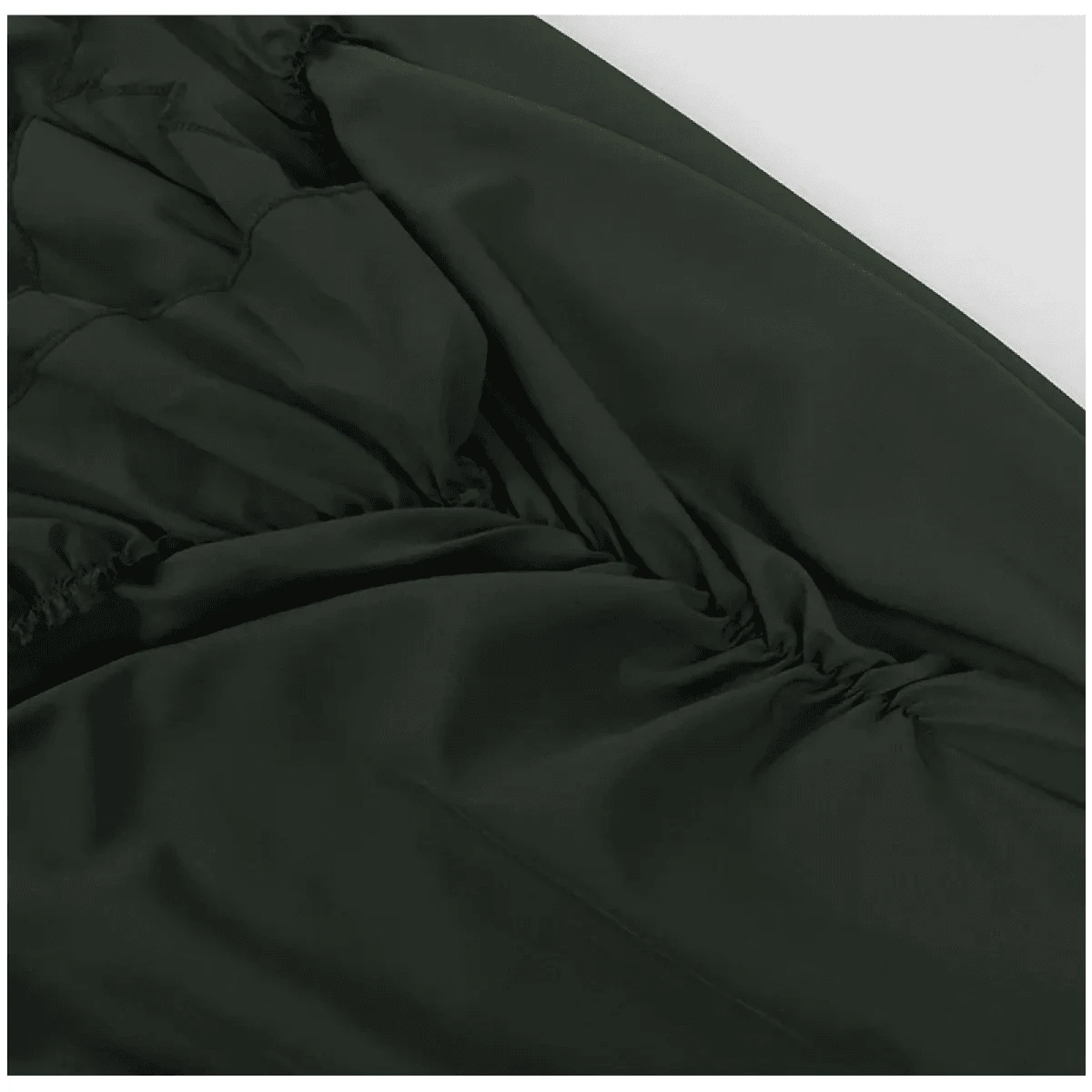 A close-up view of dark green fabric featuring gathered ruching detail along the side seam.
