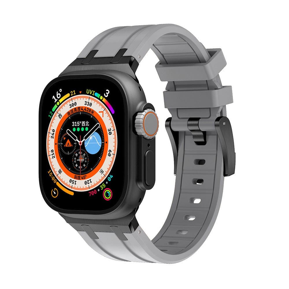 A smartwatch with a rectangular black face featuring a digital multi-function display is attached to a gray silicone watch band with a black buckle.