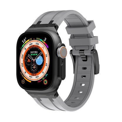 A smartwatch with a rectangular black face featuring a digital multi-function display is attached to a gray silicone watch band with a black buckle.