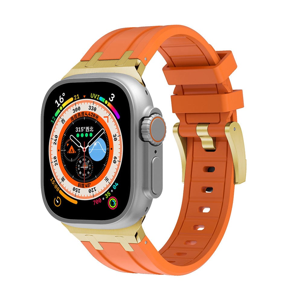 A smartwatch with a rectangular silver case and an orange silicone band featuring gold-tone metal accents.