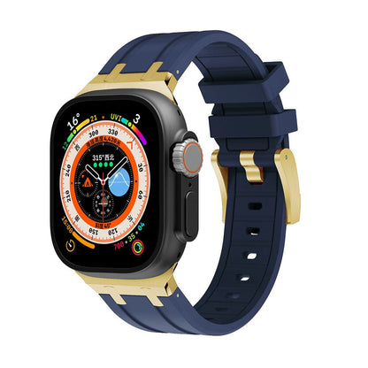 A smartwatch with a dark gray rectangular screen and a multi-functional watch face, attached to a navy blue silicone band with gold-tone hardware.
