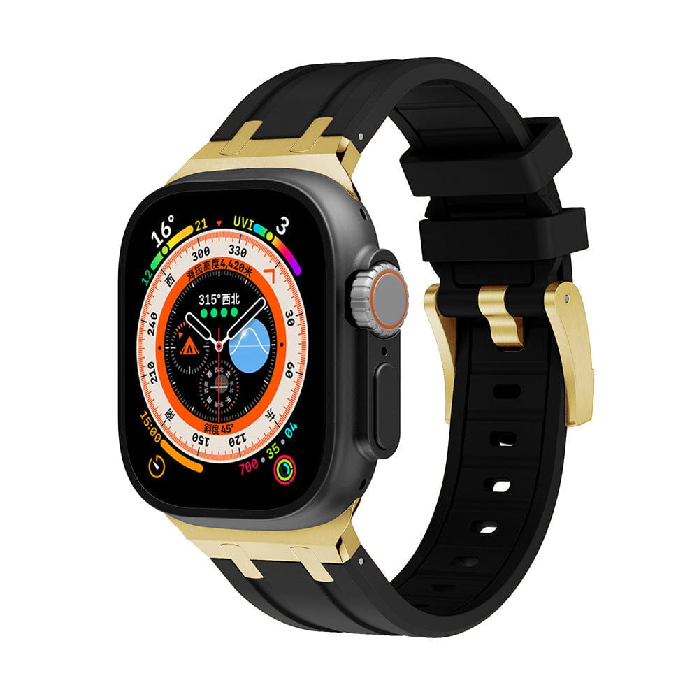 A smartwatch with a square screen displaying a complex digital watch face, housed in a gold-colored frame and attached to a black silicone watch band with a gold buckle.